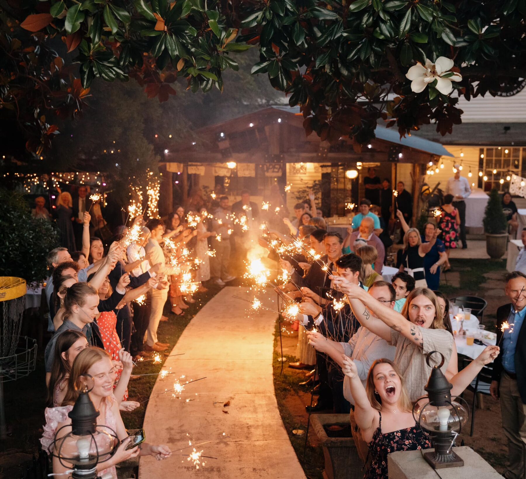 Guests celebrating with sparklers on the patio