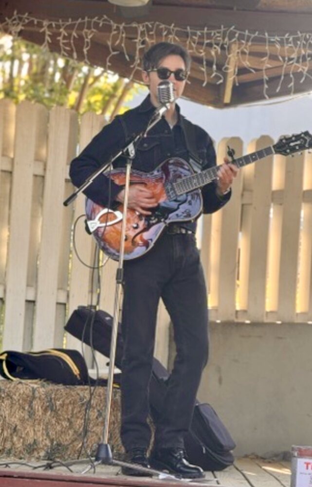 A musician performing on the patio stage